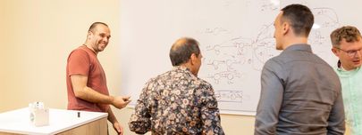 Legacy Software Menschen bei bluehands vor einem Whiteboard im Gespräch